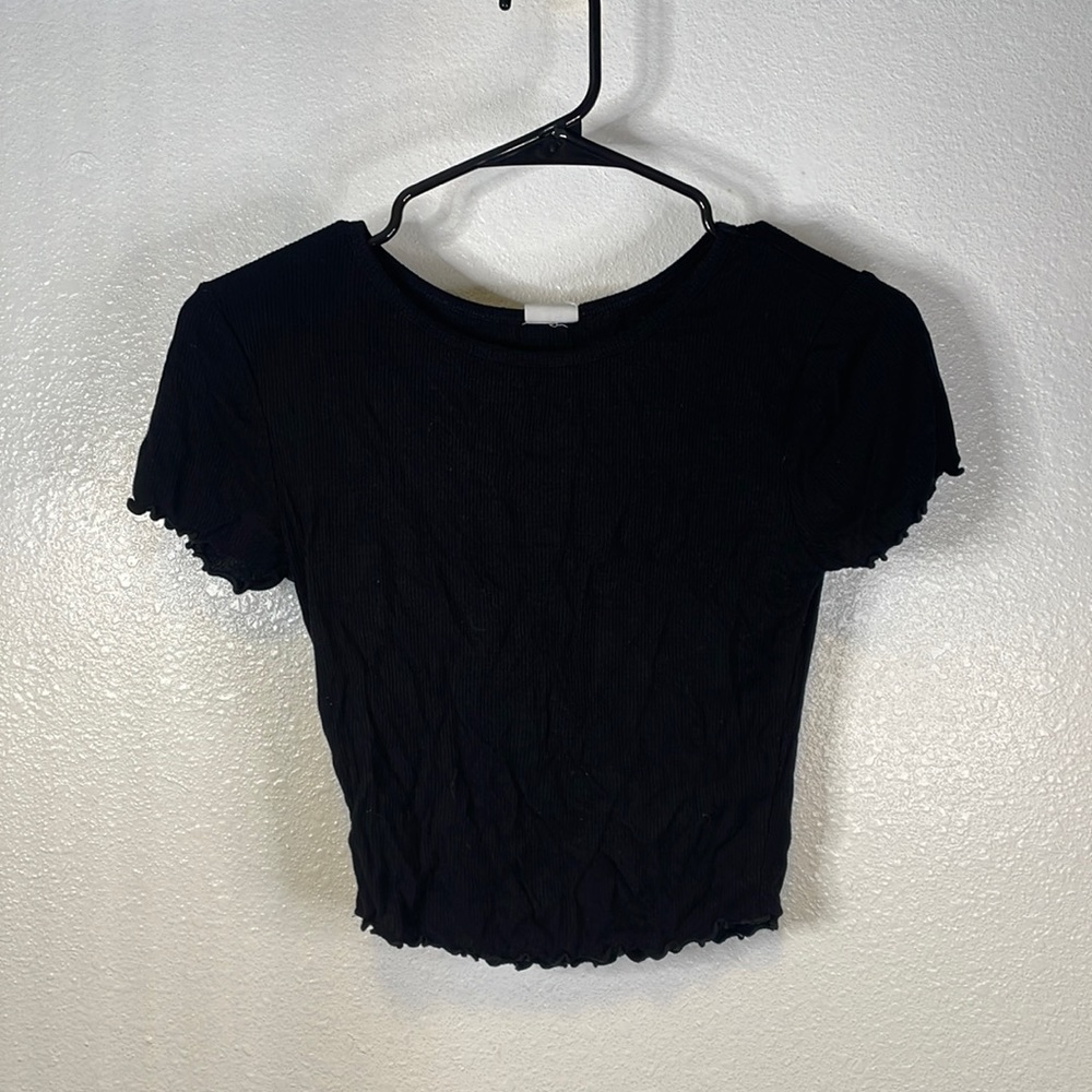 Ruffled on sleeves and bottom of shirt.